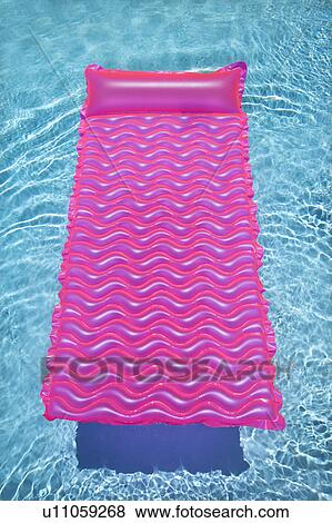 Pink lounge float in empty swimming pool with rippling blue water. View Large Photo Image Stock Photo - Pink lounge float in empty swimming pool with rippling blue water.. Fotosearch