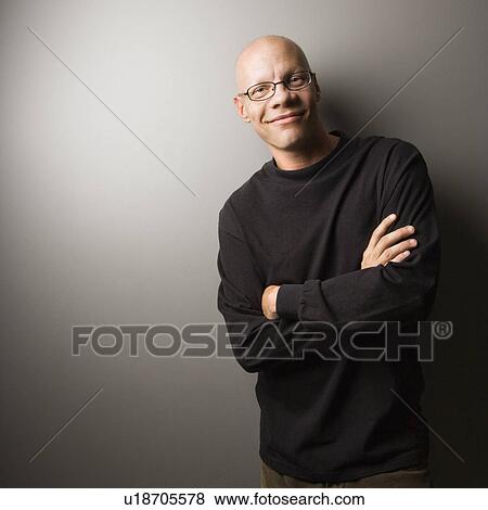Portrait of mid-adult Caucasian male with crossed arms. View Large Photo Image Stock Photo - Portrait of mid-adult Caucasian male with crossed arms.. Fotosearch