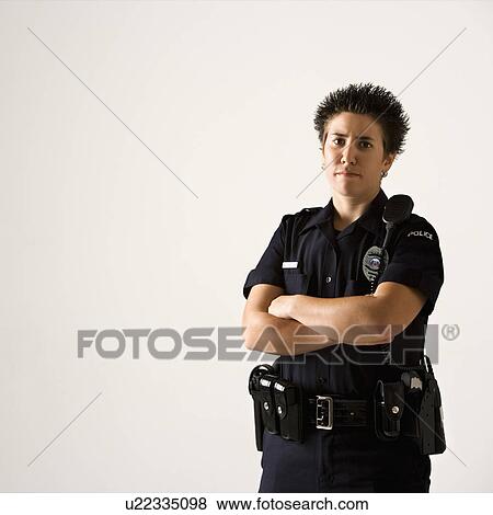 Portrait of mid adult Caucasian policewoman standing with hand on gun holster looking at viewer. View Large Photo Image Stock Photo - Portrait of mid adult Caucasian policewoman standing with hand on gun holster looking at viewer.. Fotosearch