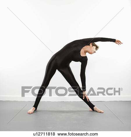 Portrait of pretty Caucasian woman in spandex bodysuit leaning and stretching to side. View Large Photo Image Stock Photo - Portrait of pretty Caucasian woman in spandex bodysuit leaning and stretching to side.. Fotosearch