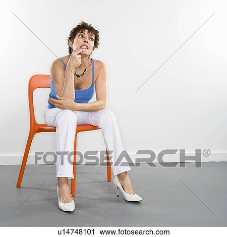 Portrait of pretty Caucasian woman sitting in modern chair. View Large Photo Image Stock Image - Portrait of pretty Caucasian woman sitting in modern chair.. Fotosearch