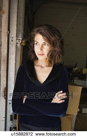 Portrait of pretty Caucasian woman standing with arms crossed. View Large Photo Image Stock Image - Portrait of pretty Caucasian woman standing with arms crossed.. Fotosearch