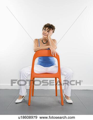 Portrait of pretty Caucasian woman sitting in modern chair. View Large Photo Image Stock Photo - Portrait of pretty Caucasian woman sitting in modern chair.. Fotosearch