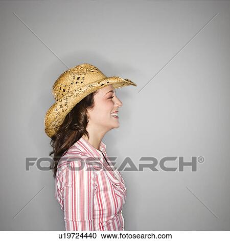 Profile of young Caucasian woman wearing cowboy hat smiling. View Large Photo Image Stock Image - Profile of young Caucasian woman wearing cowboy hat smiling.. Fotosearch
