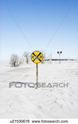 Stock Photo - Railroad crossing sign in snow covered rural landscape.. Fotosearch