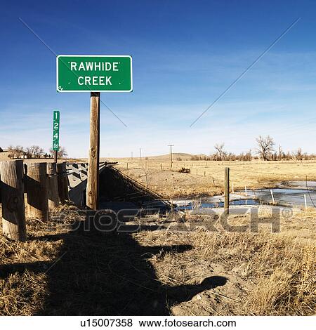 Stock Photo - Rawhide creek sign in rural landscape.. Fotosearch