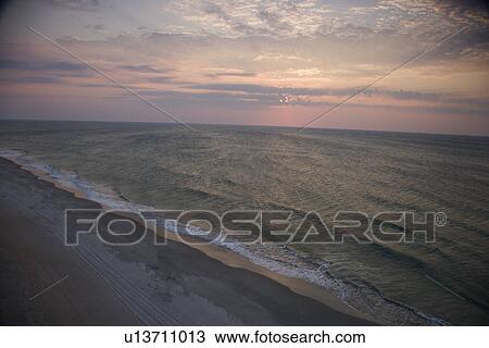 Stock Image - Scenic Bald Head Island North Carolina landscape of shoreline during sunrise.. Fotosearch