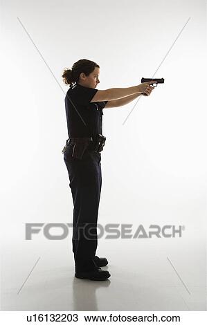 Side view of mid adult Caucasian policewoman standing and aiming handgun. View Large Photo Image Stock Image - Side view of mid adult Caucasian policewoman standing and aiming handgun.. Fotosearch