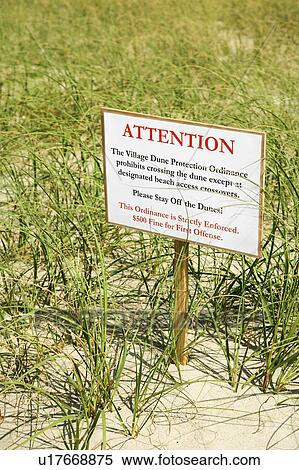 Sign warning visitors not to walk on or disturb natural dune area. View Large Photo Image Stock Photography - Sign warning visitors not to walk on or disturb natural dune area.. Fotosearch