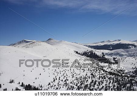 Stock Photograph - Snow covered mountain range in Colorado.. Fotosearch