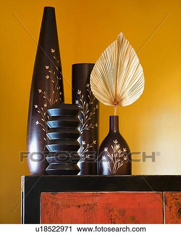 Stock Image - Still life of interior with Asian vases on dresser.. Fotosearch