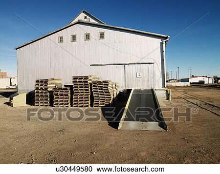 Storage warehouse with ramp and palettes in rural setting. View Large Photo Image Stock Image - Storage warehouse with ramp and palettes in rural setting.. Fotosearch