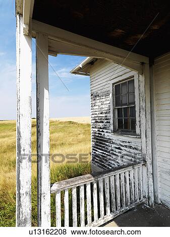 View from porch of weathered abandoned building in grassland. View Large Photo Image Stock Photo - View from porch of weathered abandoned building in grassland.. Fotosearch