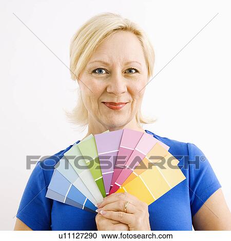 Portrait of smiling adult blonde woman holding paint swatches. View Large Photo Image Stock Image - Portrait of smiling adult blonde woman holding paint swatches.. Fotosearch