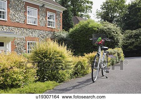 Bicycle on stand outside house View Large Photo Image Picture - Bicycle on stand outside house. Fotosearch