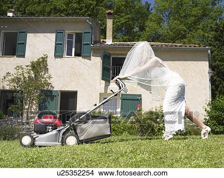Picture - Bride mowing lawn. Fotosearch