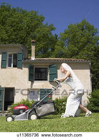 Bride trying to mow lawn View Large Photo Image Stock Photograph - Bride trying to mow lawn. Fotosearch