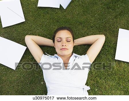 Business woman resting on grass View Large Photo Image Stock Photo - Business woman resting on grass. Fotosearch