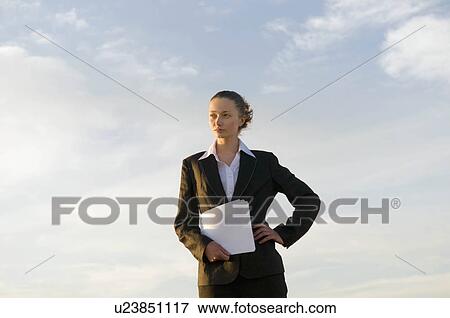 Business woman shot against sky View Large Photo Image Stock Photo - Business woman shot against sky. Fotosearch