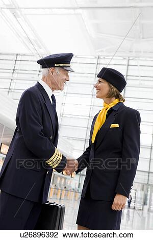 Stock Image - Flight personnel shaking hands. Fotosearch