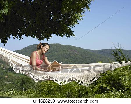 Girl reading in hammock View Large Photo Image Stock Photo - Girl reading in hammock. Fotosearch