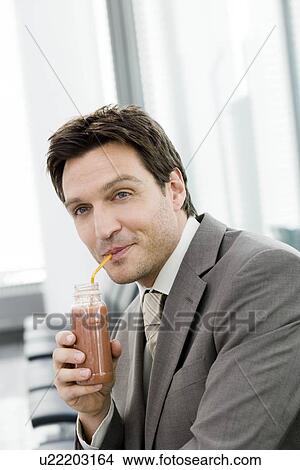 Man drinking with straw from a bottle View Large Photo Image Picture - Man drinking with straw from a bottle. Fotosearch