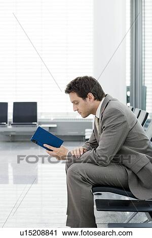 Stock Image - Man sitting reading book. Fotosearch