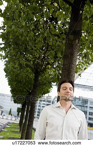 Stock Image - Man walking along eyes closed. Fotosearch