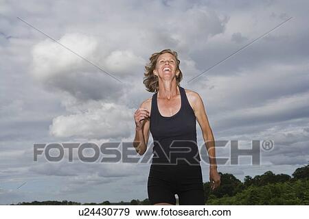 Stock Photo - Mature woman running. Fotosearch