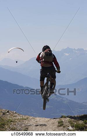Mountain biker jumping into the air View Large Photo Image Stock Photo - Mountain biker jumping into the air. Fotosearch