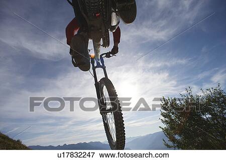 Mountain biker jumping View Large Photo Image Stock Photo - Mountain biker jumping. Fotosearch