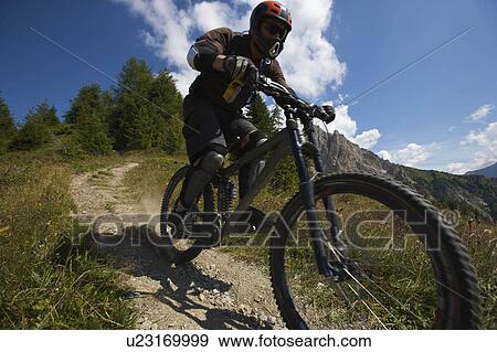 Mountain biking in the alps View Large Photo Image Stock Photo - Mountain biking in the alps. Fotosearch