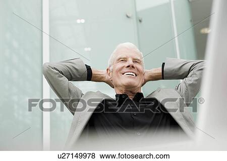 Older man leaning back in a chair View Large Photo Image Stock Photo - Older man leaning back in a chair. Fotosearch