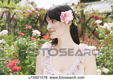 Portrait of woman with a rose in hair View Large Photo Image Stock Photo - Portrait of woman with a rose in hair. Fotosearch