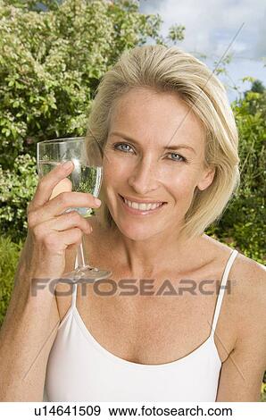 Portrait of woman with glass of water View Large Photo Image Stock Photo - Portrait of woman with glass of water. Fotosearch