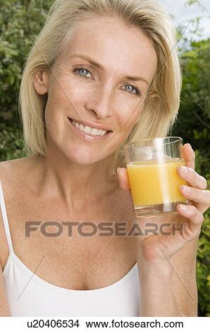 Portrait of woman with orange juice View Large Photo Image Picture - Portrait of woman with orange juice. Fotosearch