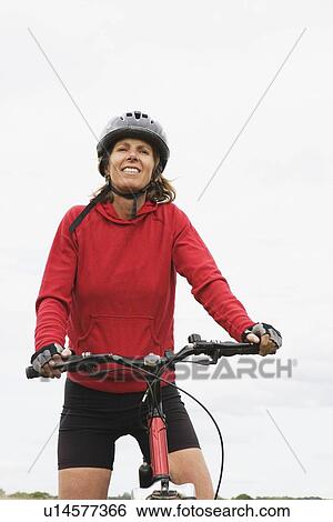 Stock Photograph - Woman cyclist on bicycle. Fotosearch