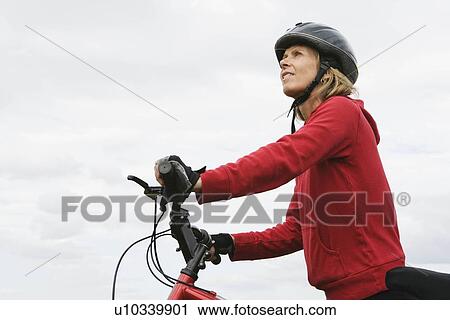 Woman cyclist pushing bicycle View Large Photo Image Stock Image - Woman cyclist pushing bicycle. Fotosearch
