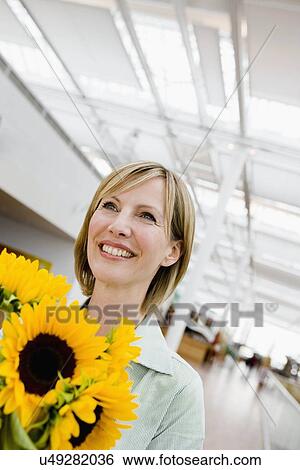 Woman receiving a bunch of flowers View Large Photo Image Stock Photograph - Woman receiving a bunch of flowers. Fotosearch
