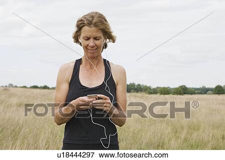 Stock Photo - Woman runner listening to music. Fotosearch