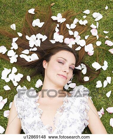 Woman surrounded with rose pedals View Large Photo Image Stock Photo - Woman surrounded with rose pedals. Fotosearch