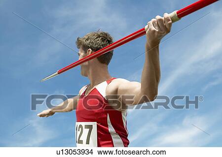 Picture - Athlete about to throw javelin half length. Fotosearch