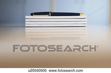 Stock Photography - Ballpoint pen on stack of notepads. Fotosearch