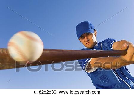 Baseball player hitting ball with bat (low angle view) View Large Photo Image Stock Image - Baseball player hitting ball with bat (low angle view). Fotosearch