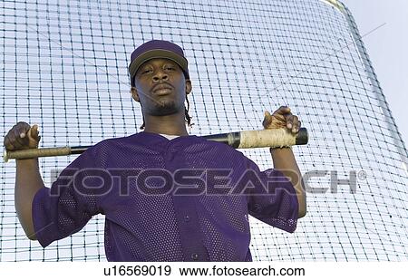 Baseball player holding bat during practice (portrait) View Large Photo Image Stock Photo - Baseball player holding bat during practice (portrait). Fotosearch