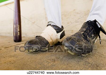 Baseball player sitting close-up of baseball shoes (low section) View Large Photo Image Stock Image - Baseball player sitting close-up of baseball shoes (low section). Fotosearch