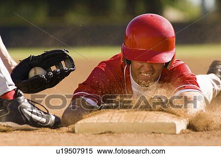Baseball player sliding into base View Large Photo Image Stock Photography - Baseball player sliding into base. Fotosearch