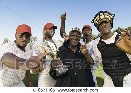 Stock Photography - Baseball team and coach celebrating victory outdoors (portrait). Fotosearch