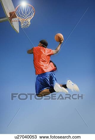 Basketball player shooting with ball low angle view View Large Photo Image Stock Image - Basketball player shooting with ball low angle view. Fotosearch