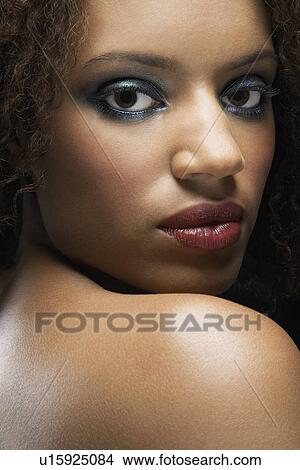 Beautiful Young Woman looking over shoulder View Large Photo Image Picture - Beautiful Young Woman looking over shoulder. Fotosearch
